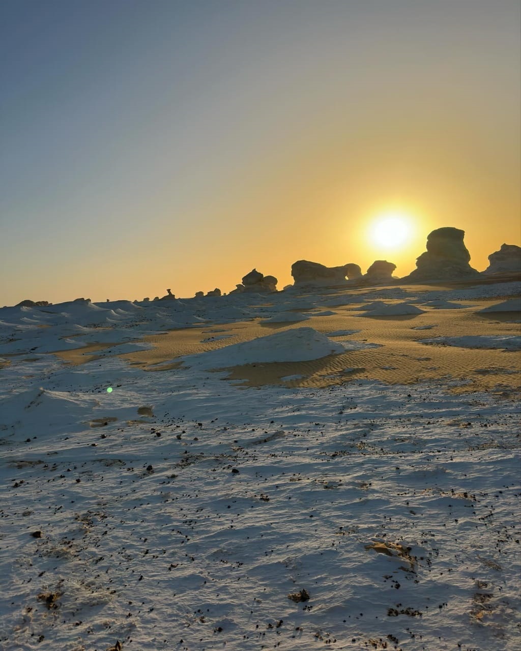A view of the stark white geological formations of the White Desert
