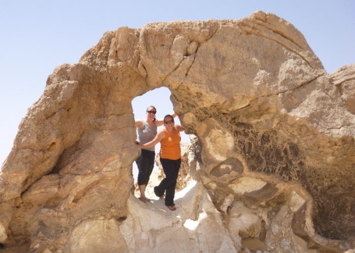 Due amici sorridenti che posano per una foto davanti alle formazioni di cristalli scintillanti della Montagna di Cristallo in Egitto