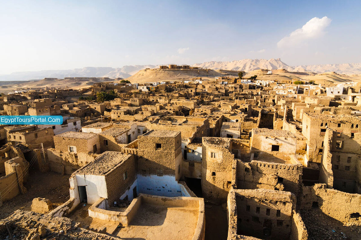 The intricate, ancient mud-brick architecture of Al-Qasr village in Dakhla Oasis, displaying historical charm and narrow alleyways
