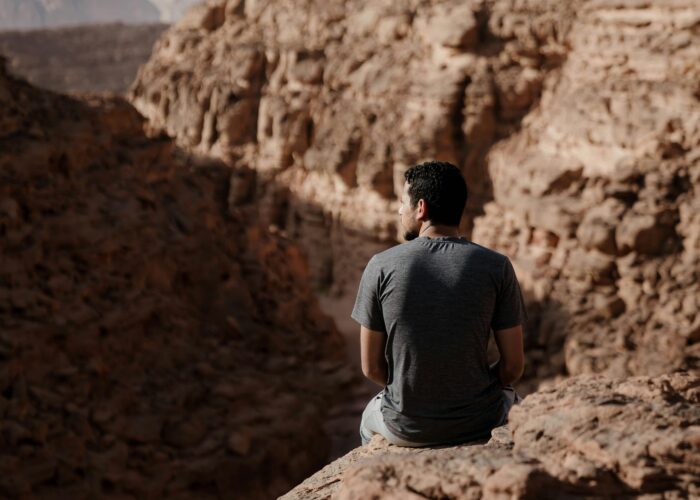 sitting peacefully on a mountain slope in Sinai, enjoying the tranquility of the desert landscape