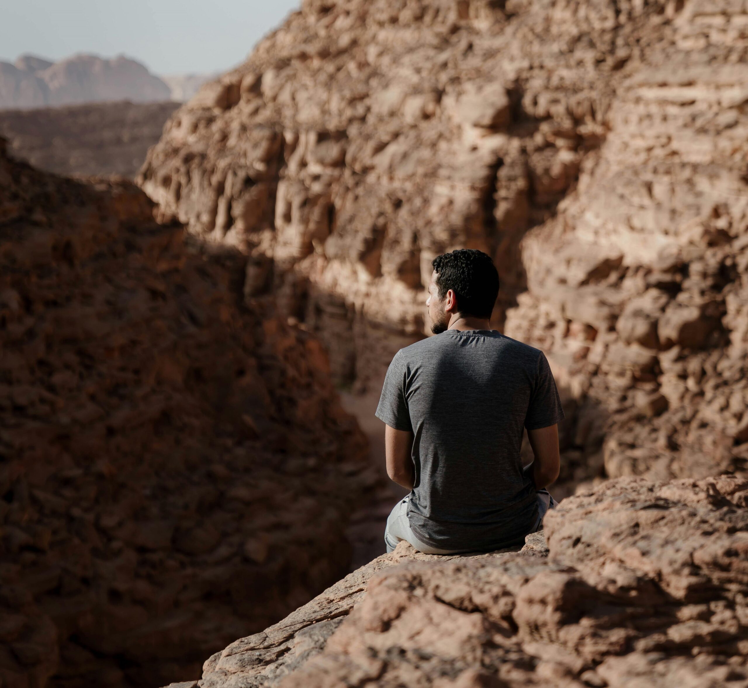 sitting peacefully on a mountain slope in Sinai, enjoying the tranquility of the desert landscape